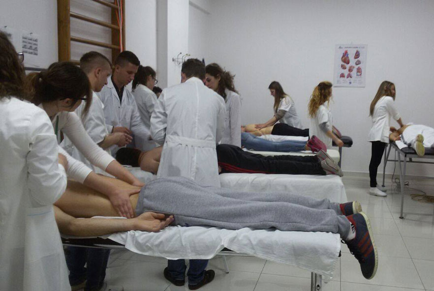 Physiotherapists work on patients lying on a table