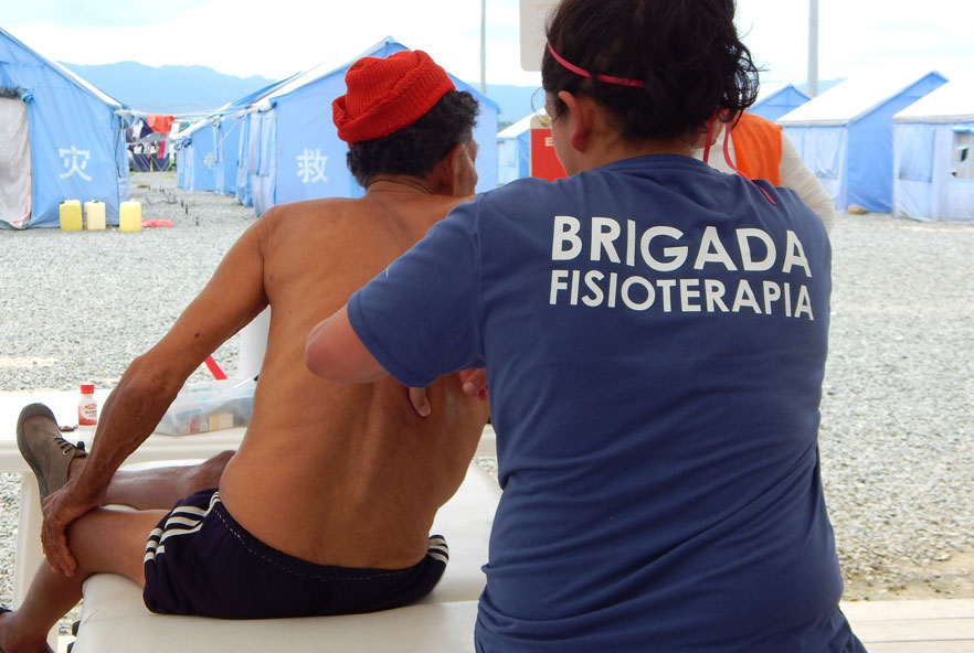 A physiotherapist massages a patient's back