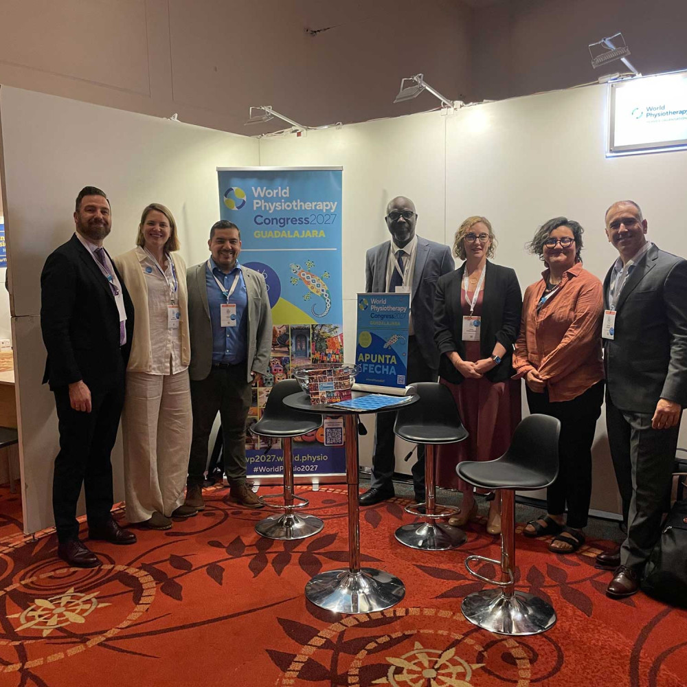 A group of professionals standing in front of an exhibition stand