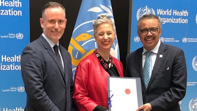 Jonathon Kruger and Emma Stokes with Tedros Adhanom Ghebreyesus, WHO Director-General 